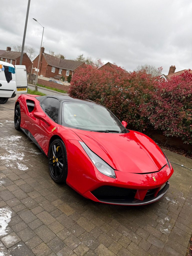 Red Ferrari 488 Spider on a block driveway, washed, dried and finished
